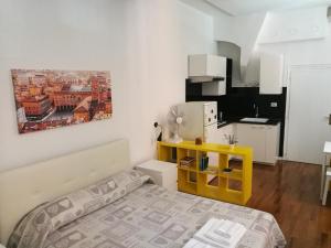 a small bedroom with a bed and a yellow table at Residenza Porta Maggiore in Bologna