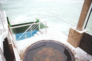 a boat with a bowl of food on the deck at Kolyada Hotel in Odesa