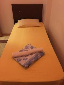 a small bed with two towels on it at Old town kagitci apart in Istanbul