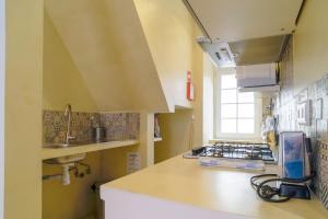 a kitchen with a sink and a counter top at Bright And Sunny Apartment in Lisbon +40 photos