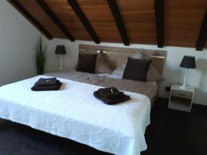 a bedroom with a white bed with two towels on it at Ferienwohnung Ruhenest in Willingen
