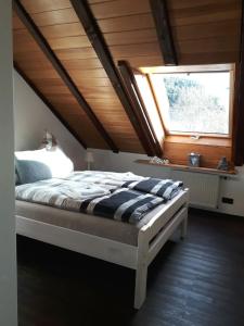 - une chambre avec un grand lit et une fenêtre dans l'établissement Ferienwohnung Ruhenest, à Willingen