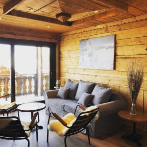 a living room with a couch and a table at Les Chalets du Thorens in Val Thorens