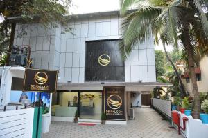 a building with two signs in front of it at De Falcon Goa Beach Resort in Candolim