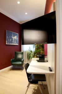 a room with a desk with a computer and a chair at OFFICINA TESINI Guest Rooms Verona in Verona