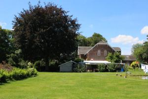 a large yard with a large brick house at Villa Wambach in Tegelen