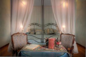 a bedroom with a bed with a table with books at Hotel Palazzo dal Borgo in Florence