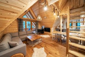 a living room and dining room in a log cabin at ZAKOPIANA in Zakopane