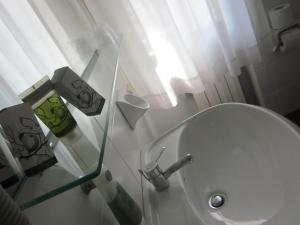 a bathroom with a white toilet and a sink at Hotel Marina in Torri del Benaco