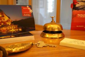 a table with a key and a book and a telephone at Hotel Adler Bärental in Feldberg