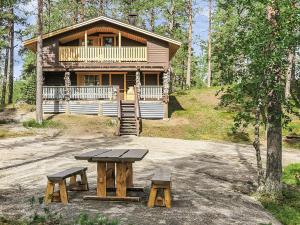 a log cabin with a picnic table in front of it at Holiday Home Ruska by Interhome in Kyrö