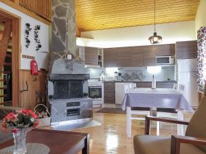 a kitchen with a large stove and a table at Holiday Home Immelkotsa 7 e by Interhome in Levi
