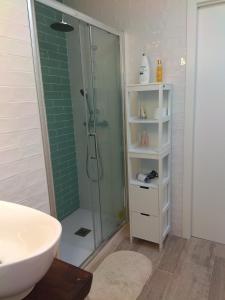 a bathroom with a glass shower and a sink at Abá apartamento in Almería