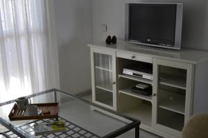 a living room with a television on a cabinet at Apartamento Cabo de Gata in Retamar