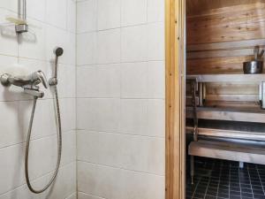 a shower with a hose in a bathroom at Holiday Home Ruska by Interhome in Kyrö