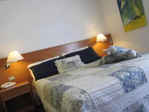 a bedroom with a bed with two pillows on it at Hotel Marina in Torri del Benaco