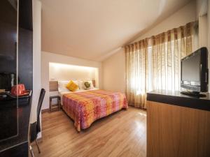 Llit o llits en una habitació de Hotel Villa Lalla