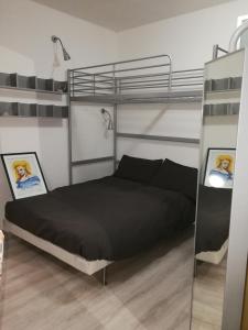 a bedroom with a bunk bed with black sheets at Enjoy Padova in Padova