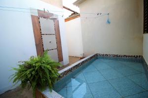 a room with a swimming pool in a house at Casa do Neguito in Olímpia