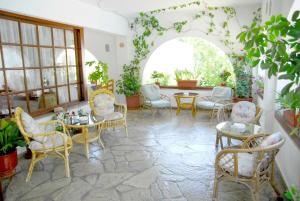 a room with chairs and tables and a large window at Afroditi in Panormos Skopelos