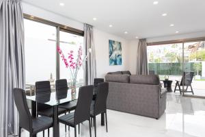 a living room with a table and a couch at Portofino Resort in Arona