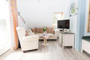 TV a/nebo společenská místnost v ubytování Hotel Garni Am Deich