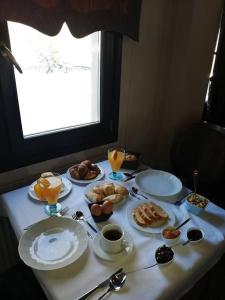 una mesa con platos de desayuno. en Andromeda Hotel Limni Plastira, en Koutsodímos