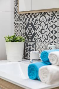 a bathroom counter with towels and a plant on it at Travel Habitat Ruzafa in Valencia