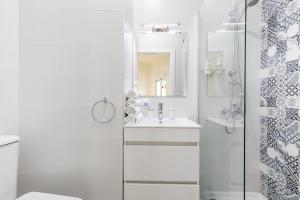 Un baño blanco con lavabo y ducha. en Travel Habitat Ruzafa Apartment, en Valencia 18 fotos más