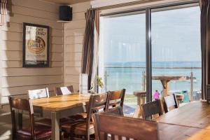 a dining room with a table and chairs and a large window at Hope & Anchor in Hope Cove