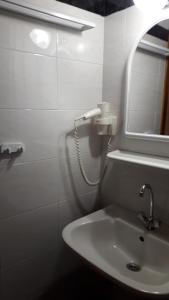 a white bathroom with a sink and a mirror at Lampos House Vourvourou in Vourvourou