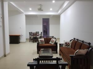 a living room with two couches and a table at Hanthana Mount View in Kandy