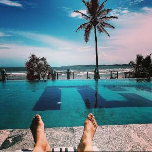 a persons feet on the edge of a swimming pool at Twenty-Two Weligambay in Weligama