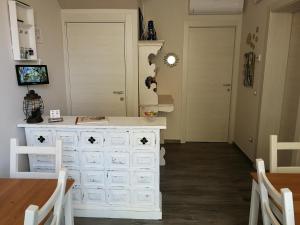 a white dresser in a room with a table and chairs at AlCivico3 in Civitanova Marche