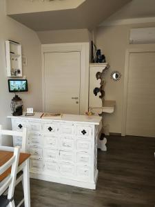 a room with a white chest of drawers and a door at AlCivico3 in Civitanova Marche