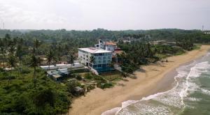 an aerial view of a building on the beach at Twenty-Two Weligambay in Weligama