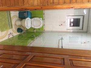 a bathroom with green and white tiles and a sink at Guest House U Myrona in Yaremche +100 photos