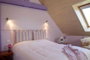 A bed or beds in a room at Logis Hotel Belle-Vue