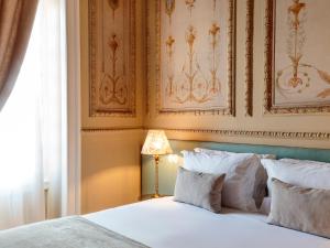 a bedroom with a white bed and a lamp at Dear Lisbon - Valmor Palace in Lisbon