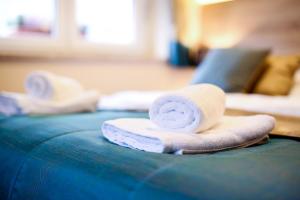 two towels sitting on top of a blue couch at Guest House Vila Moj Mir in Rateče