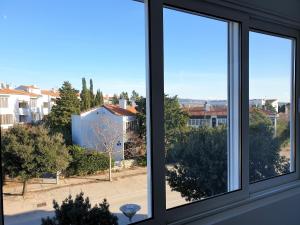a view of a city from a window at Apartment IVANA in Novalja