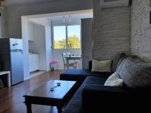 a living room with a couch and a table at Apartment IVANA in Novalja