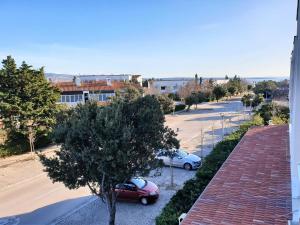 an overhead view of two cars parked in a parking lot at Apartment IVANA in Novalja