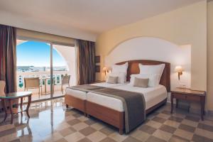 a hotel room with a bed and a balcony at Iberostar Selection Kantaoui Bay in Port El Kantaoui