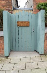 a blue gate with a sign that reads house dog snug at Sorley Boys Snug in Derry Londonderry