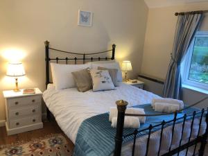 a bedroom with a large bed and a window at Marsh View Cottage, Aldeburgh in Aldeburgh