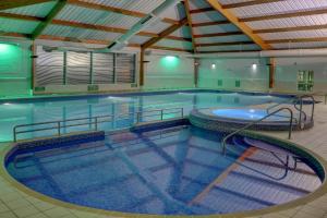 a large swimming pool in a building at Best Western Kings Manor in Edinburgh