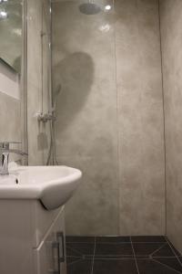 a bathroom with a sink and a glass shower at Sweetheart House in Harrogate