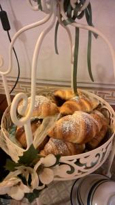 a basket filled with pastries sitting on a table at Villa Arianna B&B in Lari