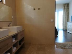 a bathroom with two sinks and a shower at Marina Holiday Rauhan Village Apartments in Imatra +33 photos